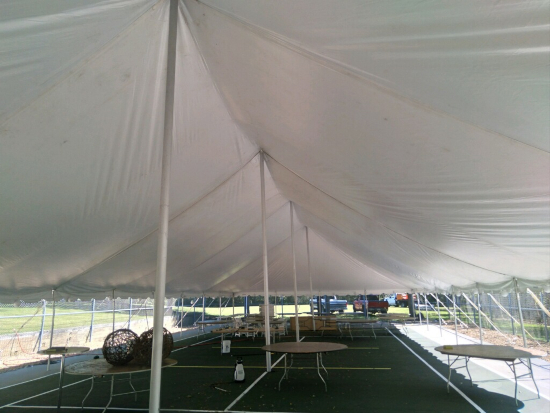 A view from under a large white tent